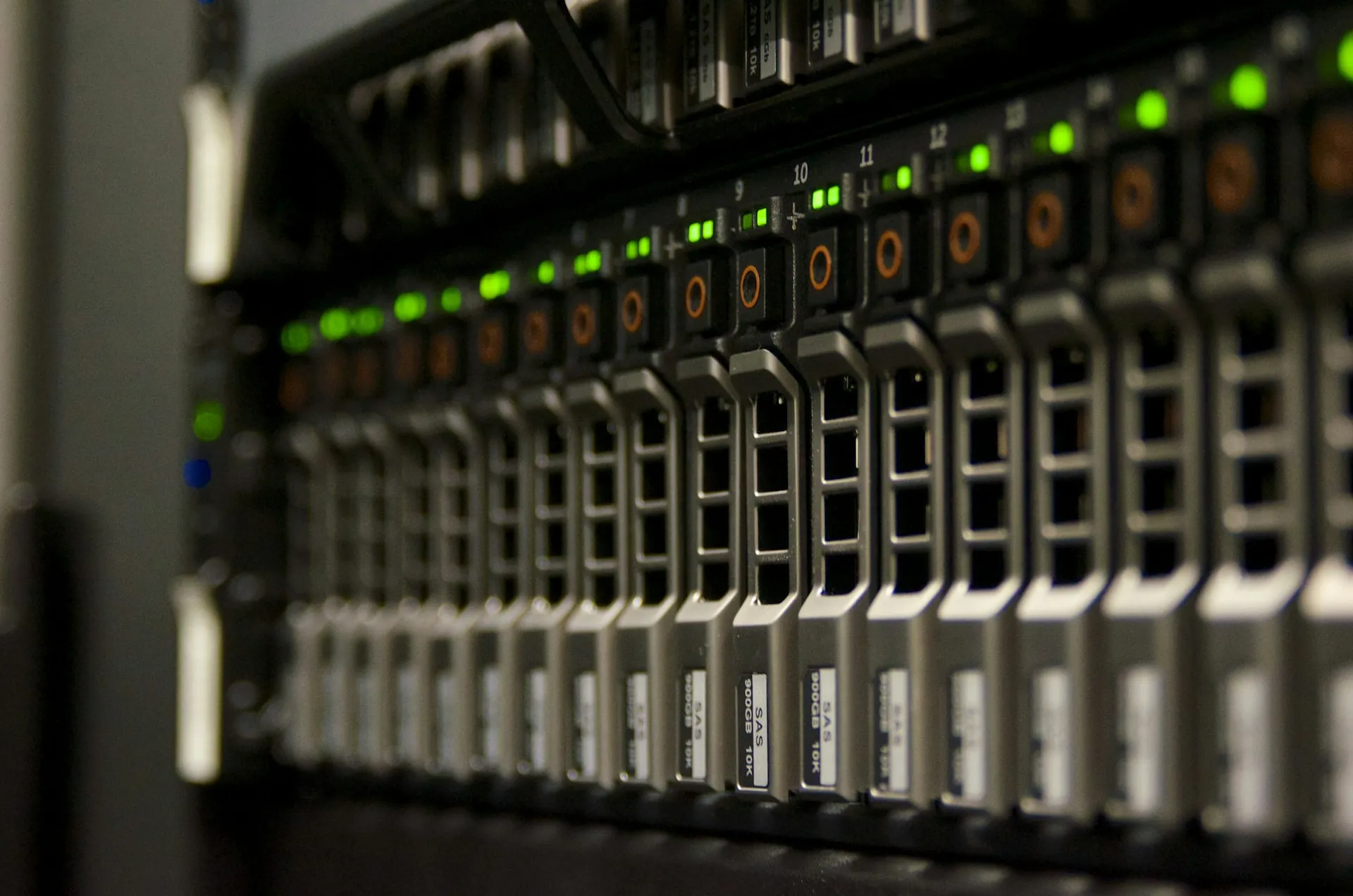 A dark row of server racks with status lights