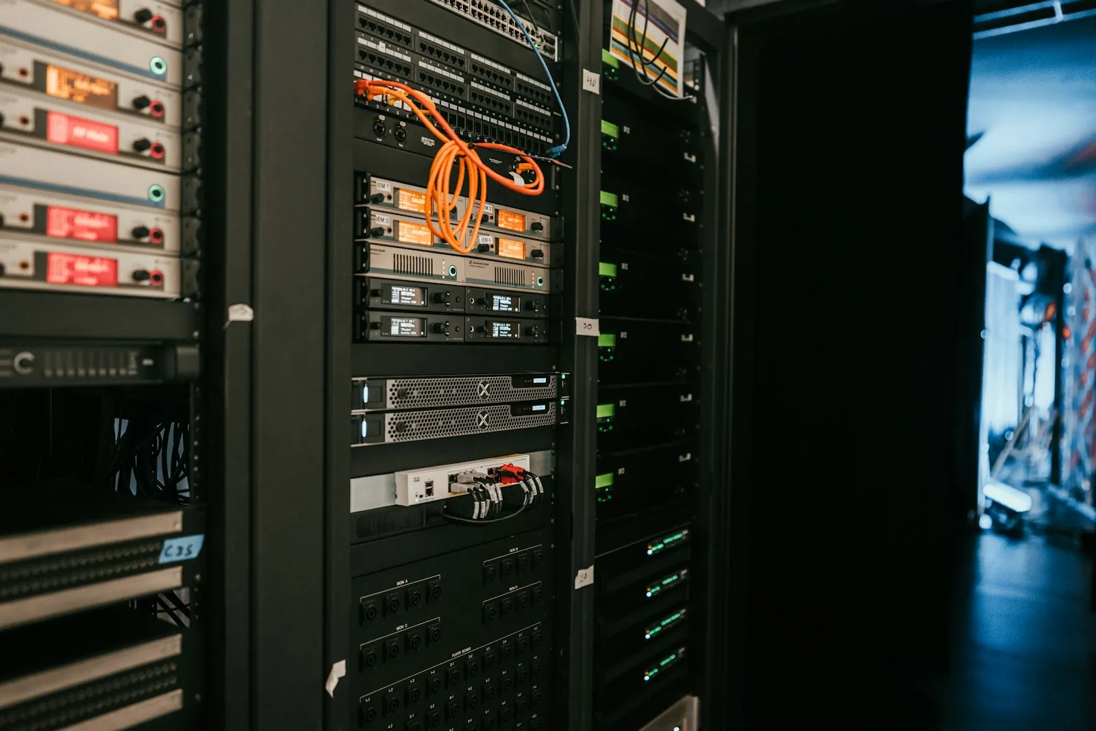 IT technician working on network cabling in a server rack